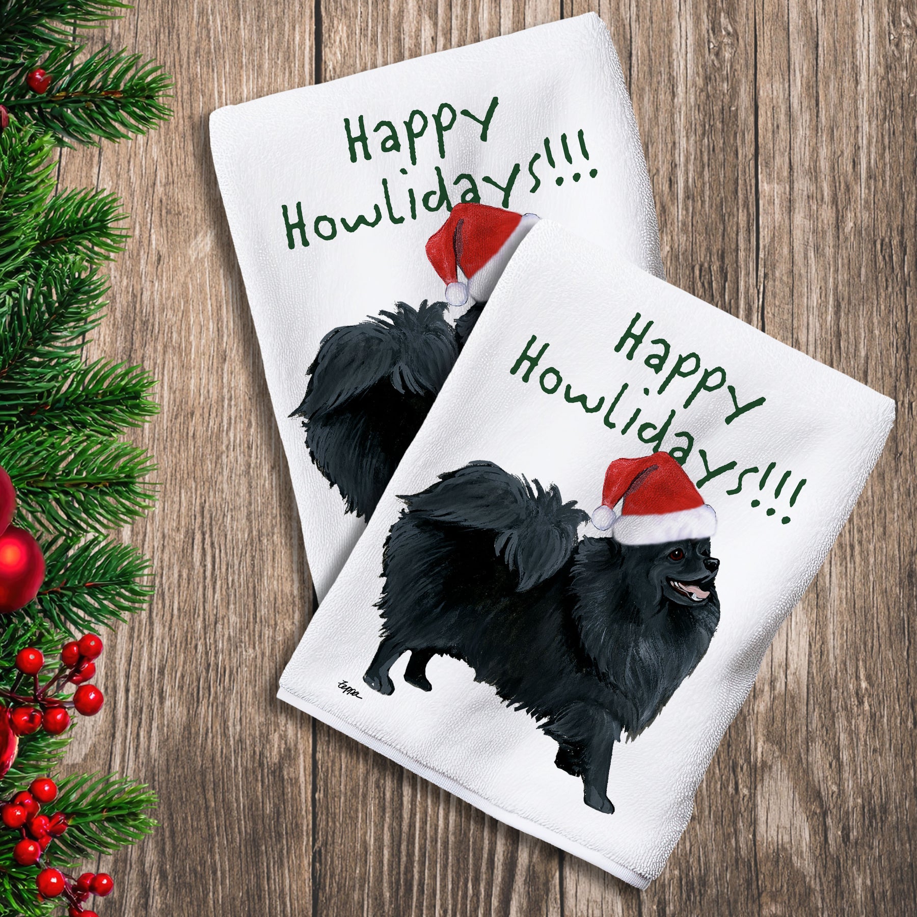 2 Kitchen Towels with a black Pomeranian in a Santa Hat and Happy Howlidays text.
