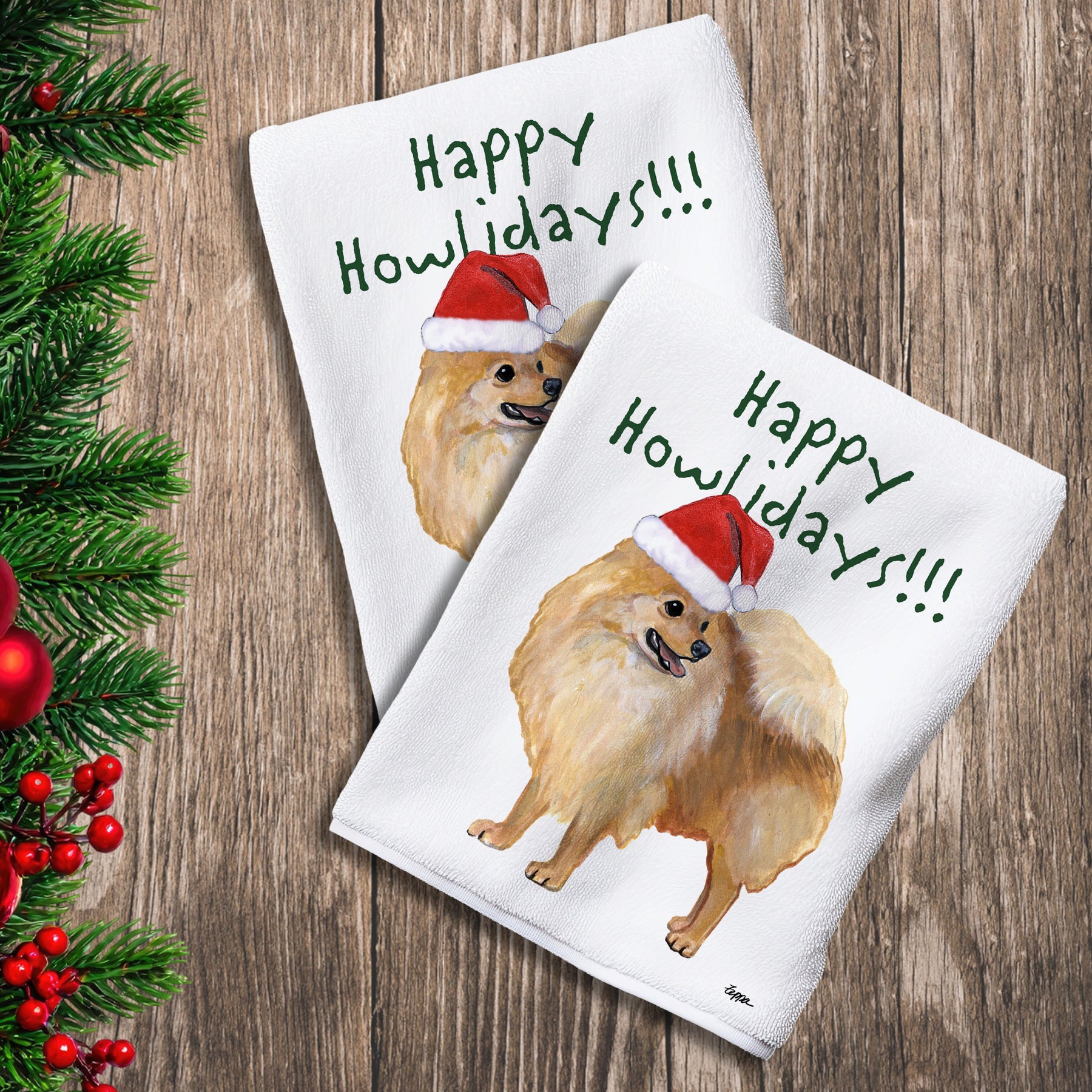 2 Kitchen Towels with a Pomeranian in a Santa Hat and Happy Howlidays text.
