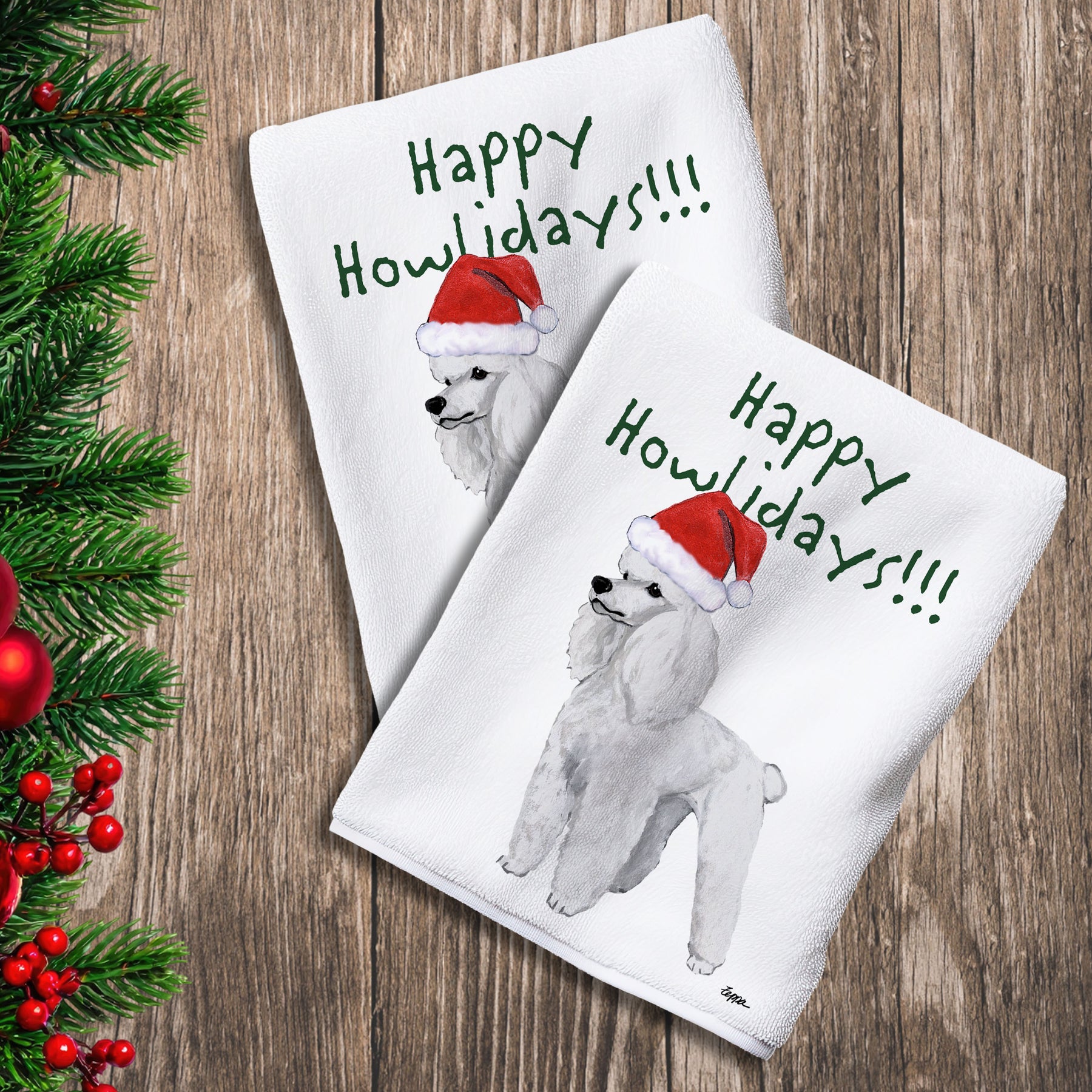2 Kitchen Towels with a white Poodle in a Santa Hat and Happy Howlidays text.
