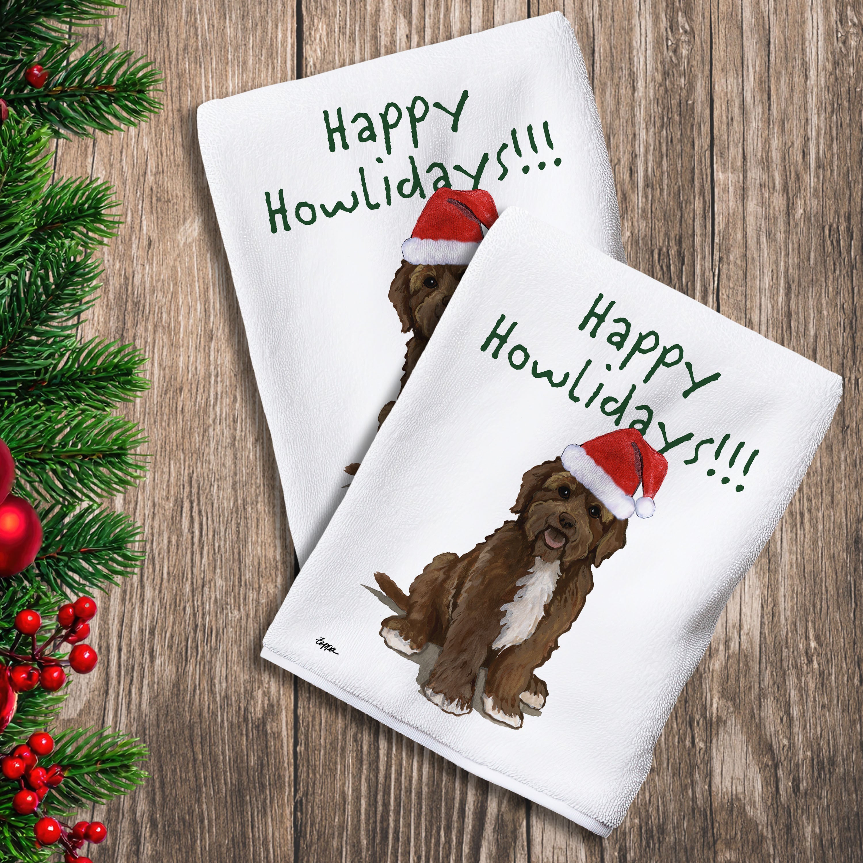 2 Kitchen Towels with a brown Portuguese Water Dog in a Santa Hat and Happy Howlidays text.
