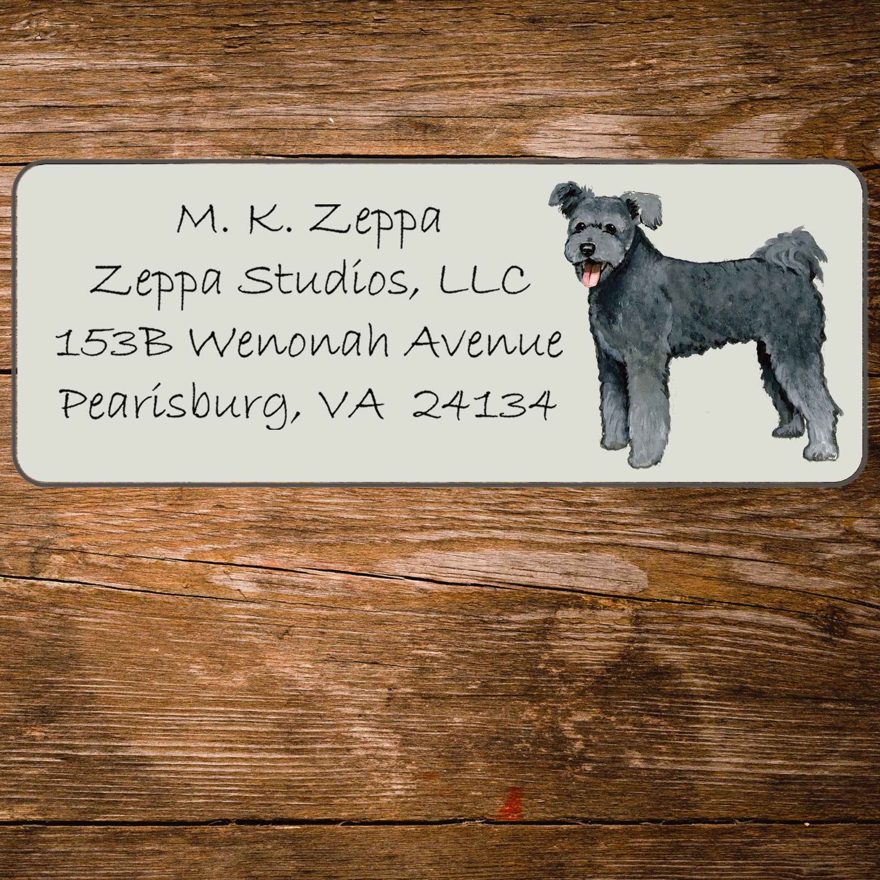 Return address label with an illustration of a Pumi
