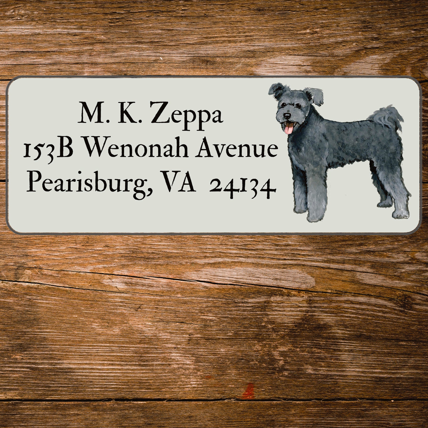 Return address label with an illustration of a Pumi