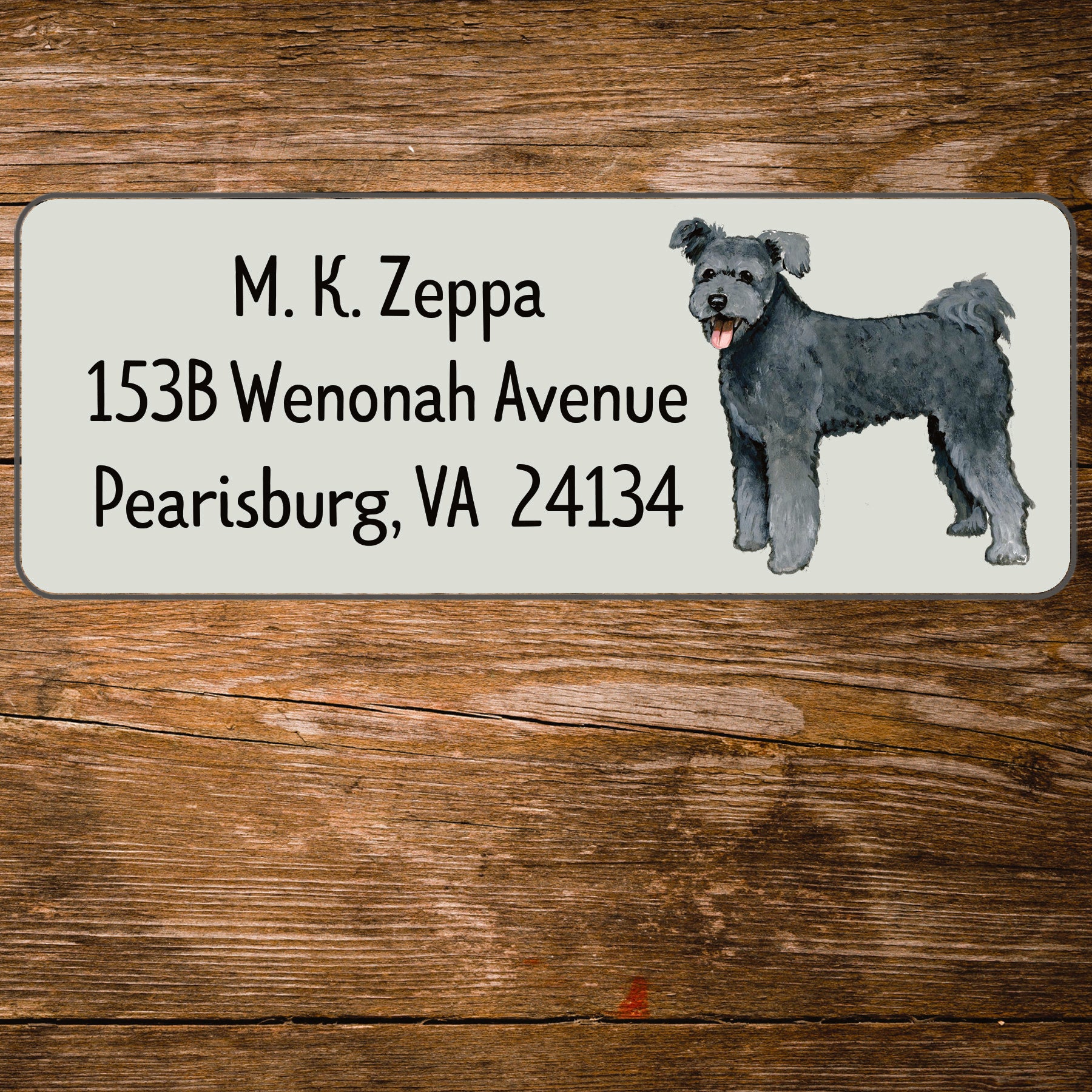 Return address label with an illustration of a Pumi