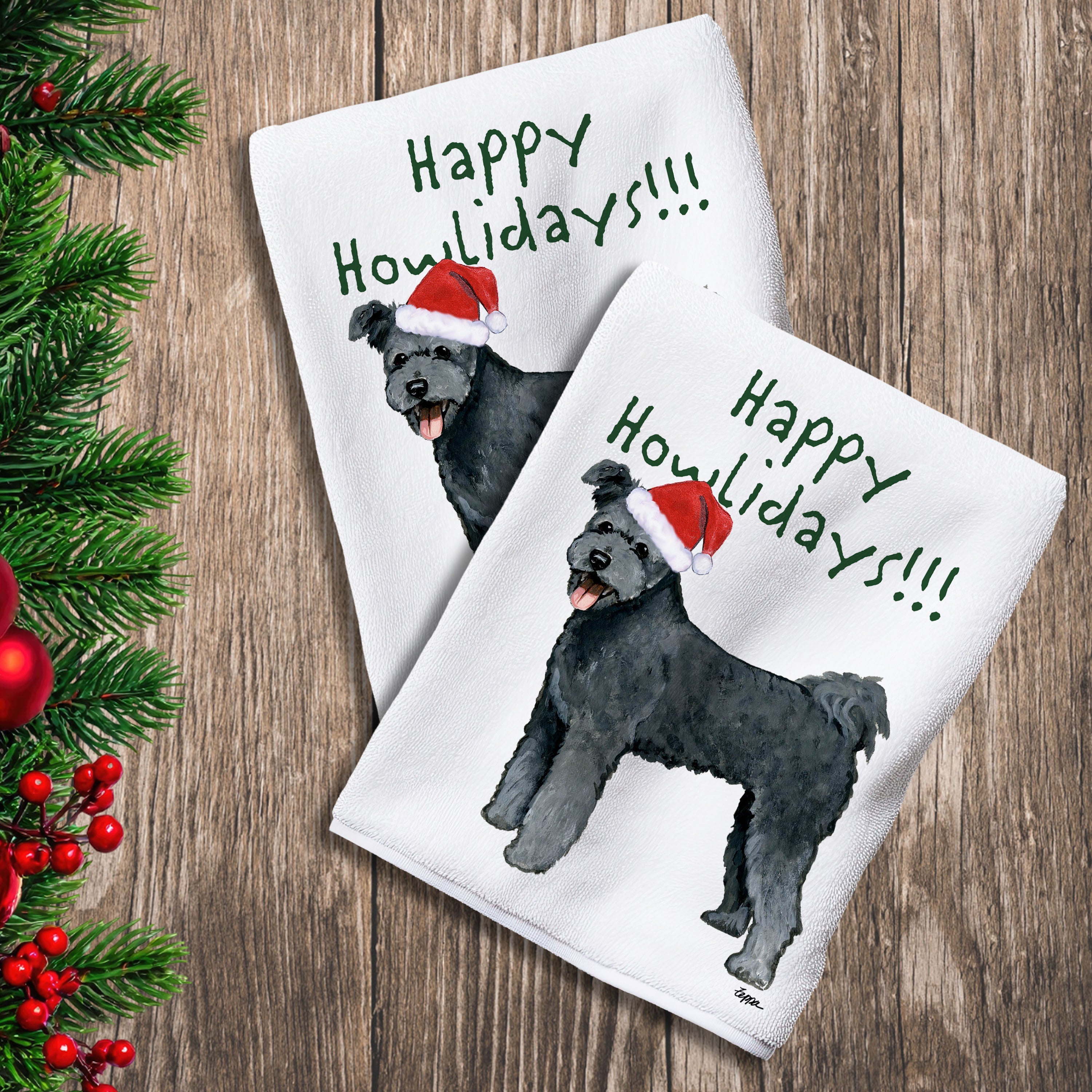 2 Kitchen Towels with a Pumi in a Santa Hat and Happy Howlidays text.