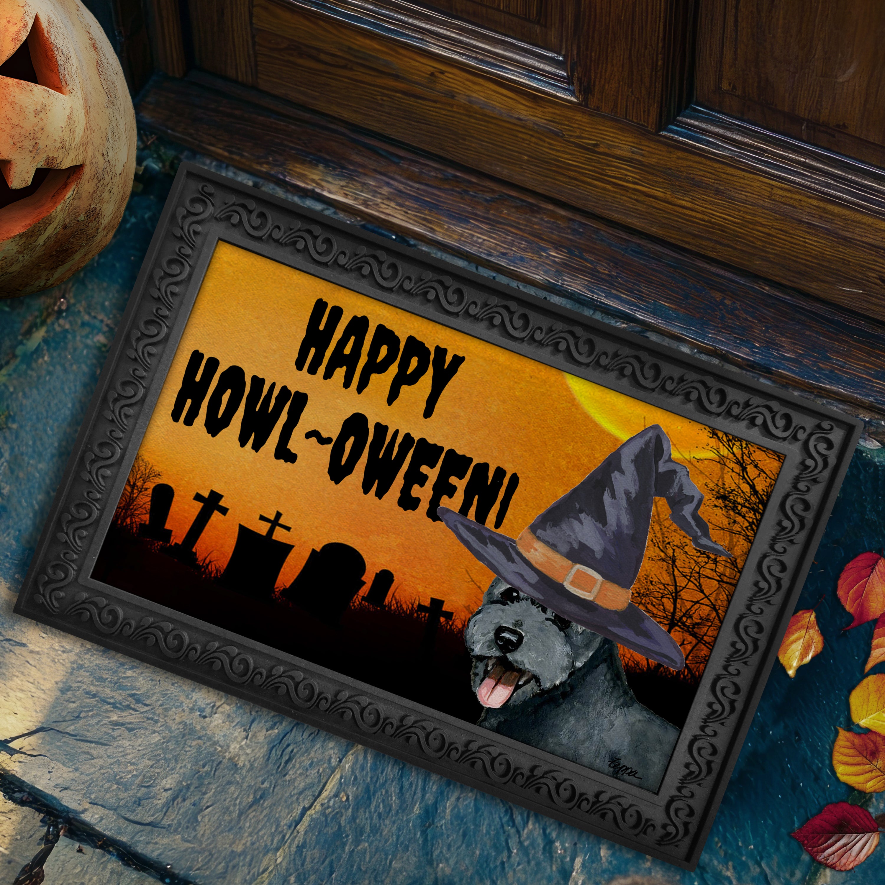Pumi in a witch's hat on a Happy Howl-ween doormat.