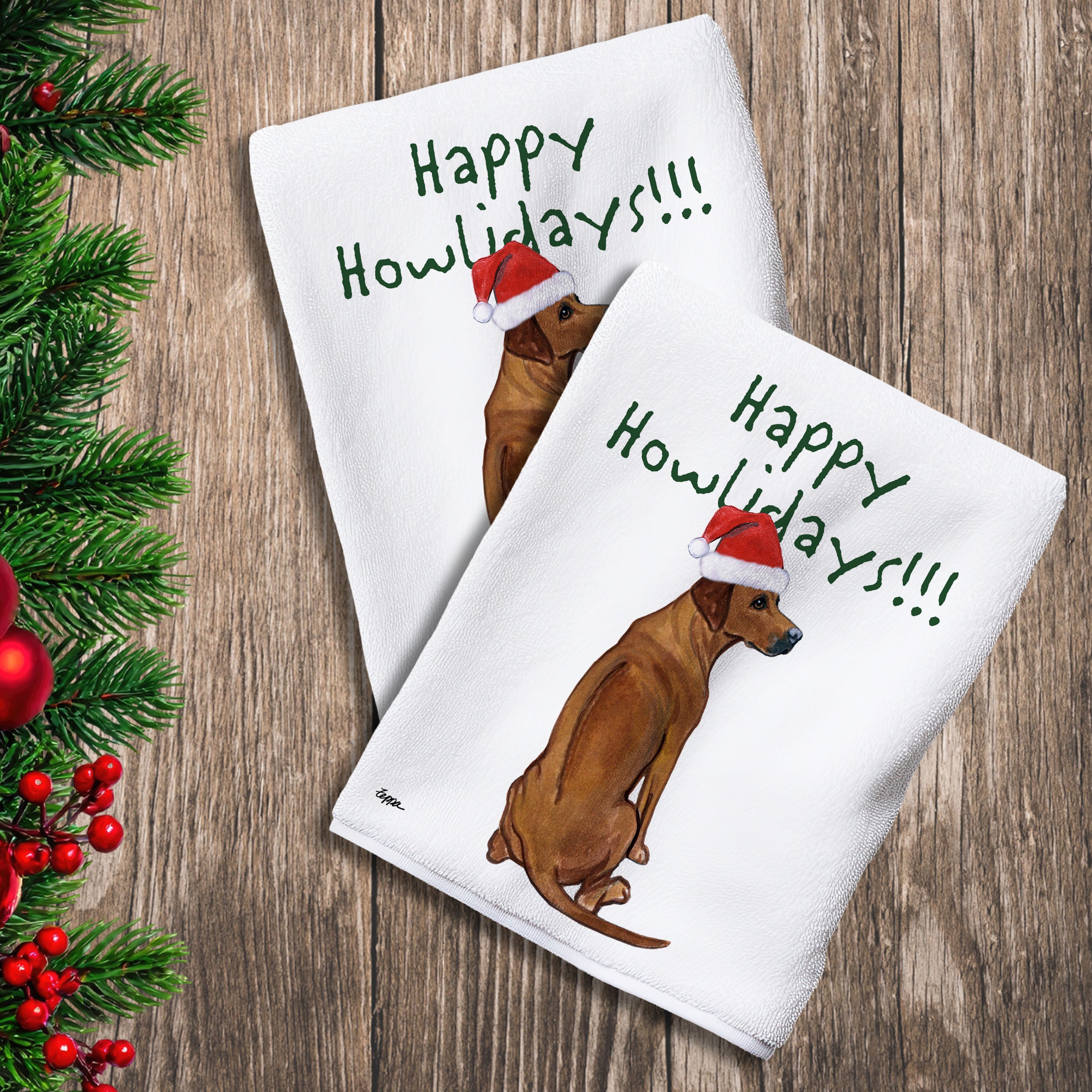 2 Kitchen Towels with a Rhodesian Ridgeback in a Santa Hat and Happy Howlidays text.
