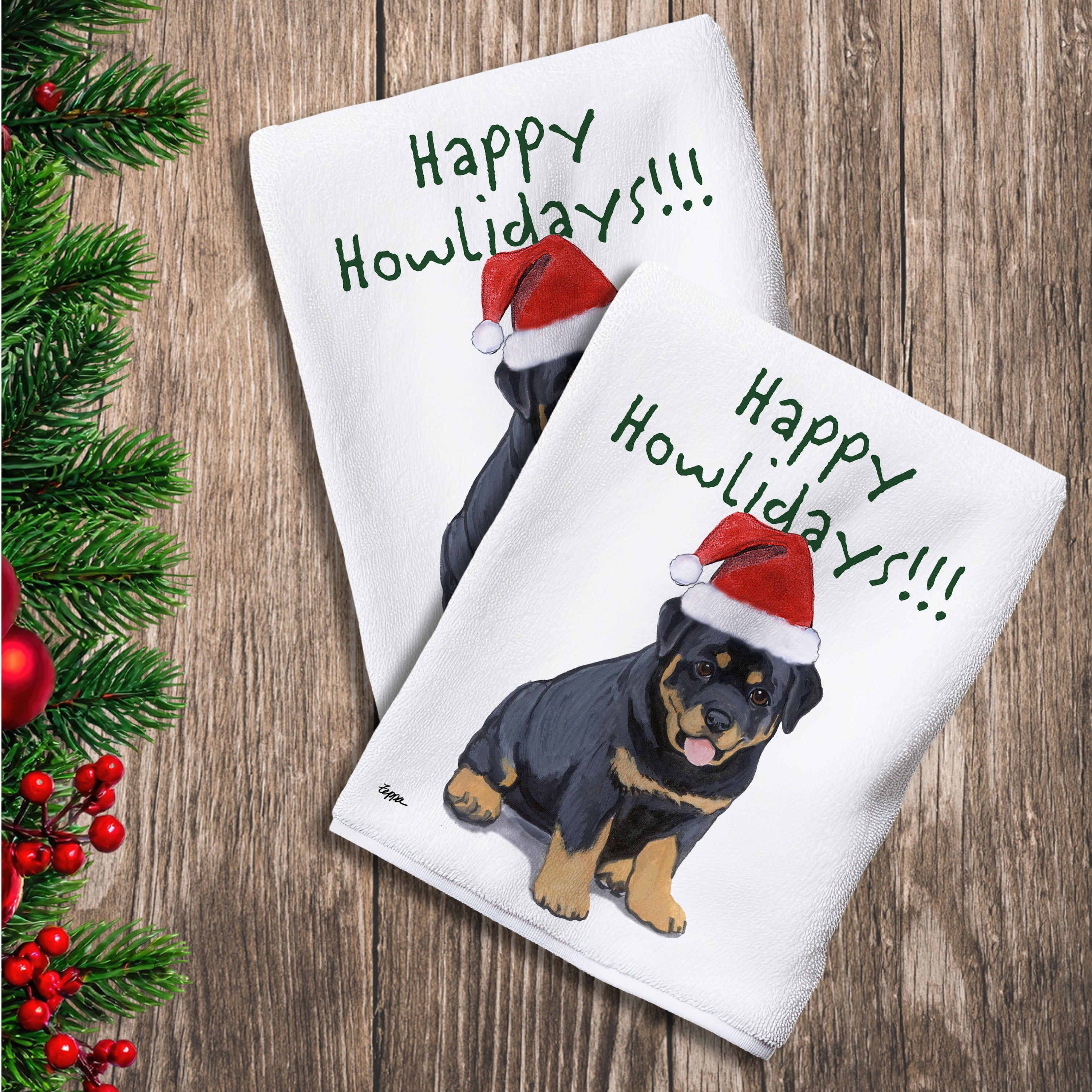 2 Kitchen Towels with a Rottweiler puppy in a Santa Hat and Happy Howlidays text.
