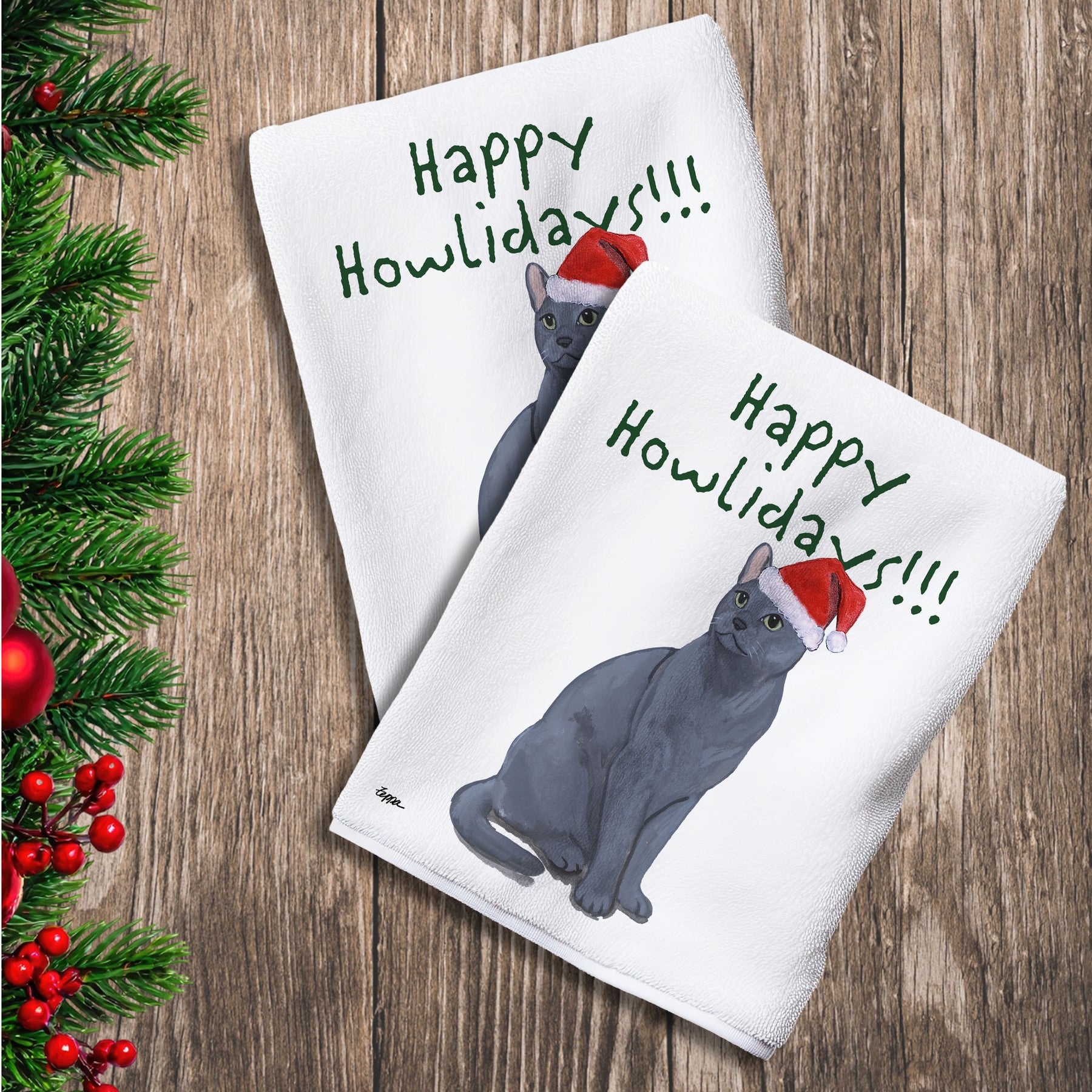 2 Kitchen Towels with a Russian Blue Cat in a Santa Hat and Happy Howlidays text.
