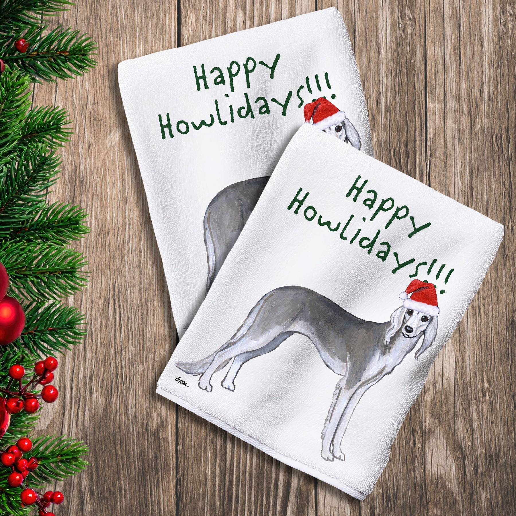 2 Kitchen Towels with a Saluki in a Santa Hat and Happy Howlidays text.
