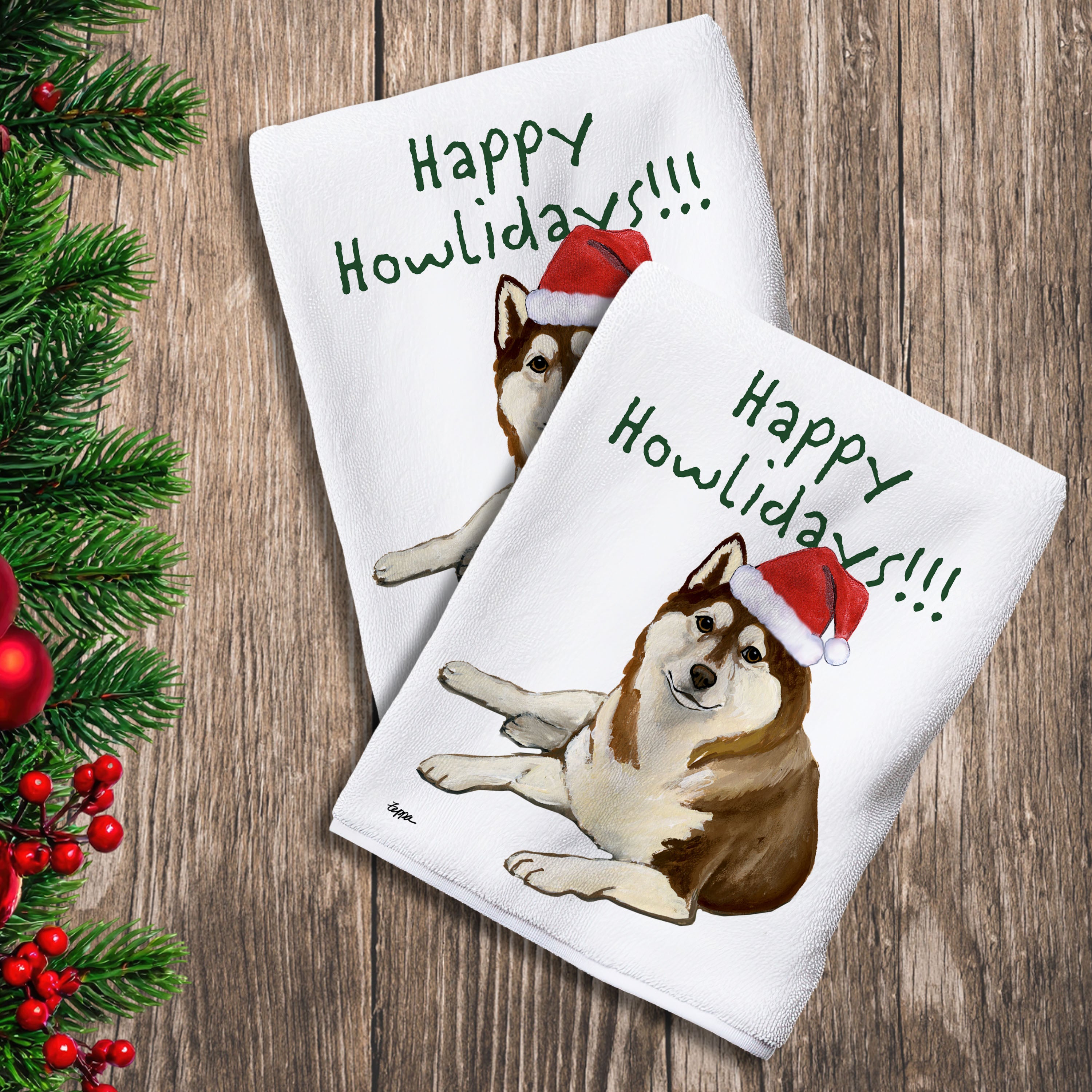 2 Kitchen Towels with a brown and white Siberian Husky in a Santa Hat and Happy Howlidays text.
