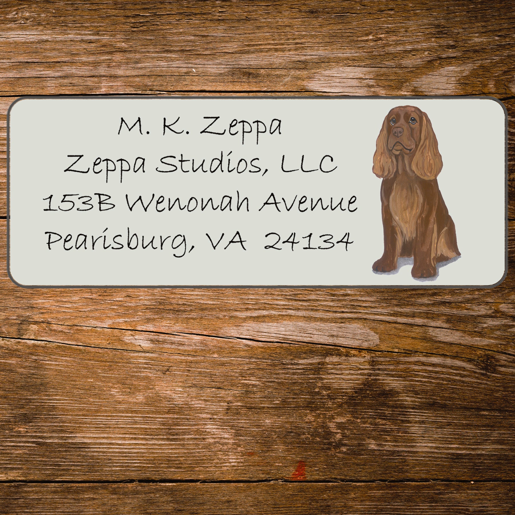 Return address label with a Sussex Spaniel illustration.