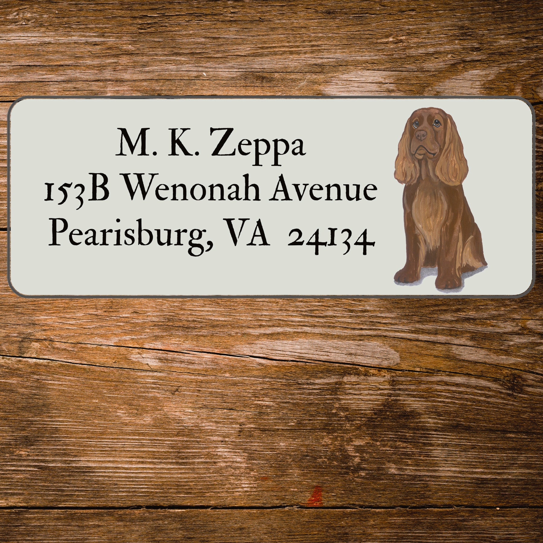 Return address label with a Sussex Spaniel illustration.