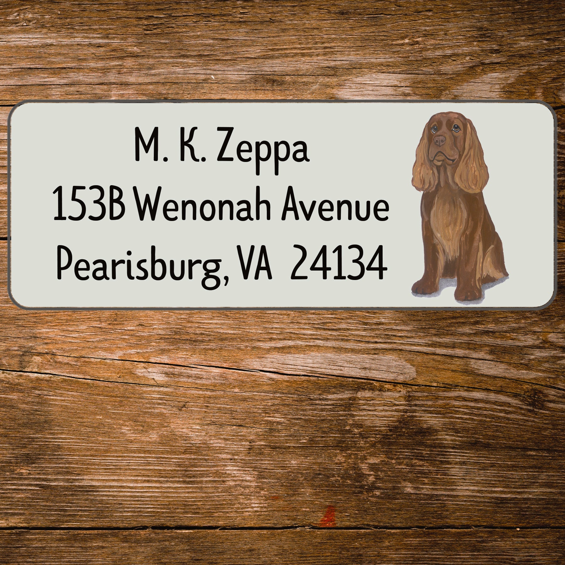 Return address label with a Sussex Spaniel illustration.