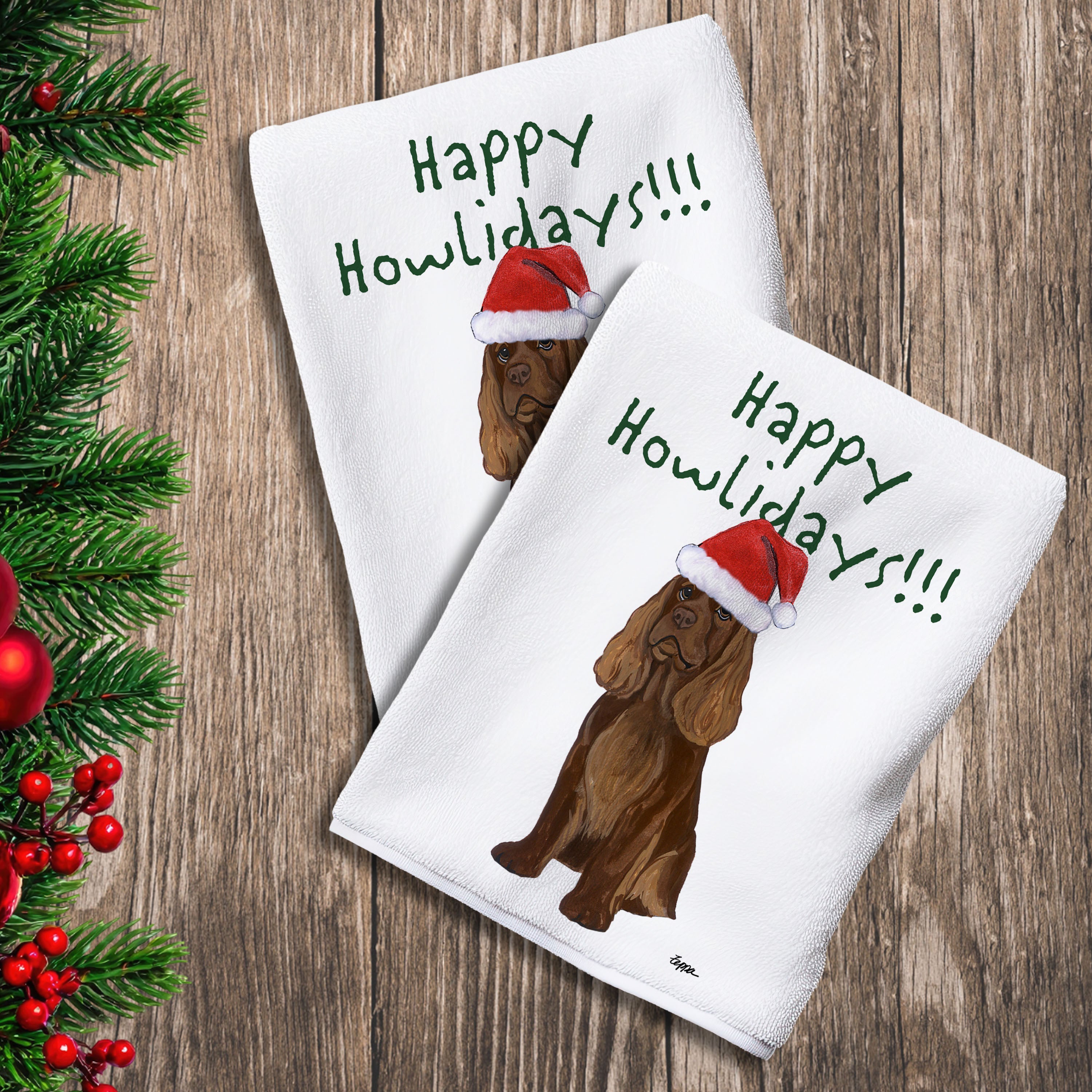 2 Kitchen Towels with a Sussex Spaniel in a Santa Hat and Happy Howlidays text.
