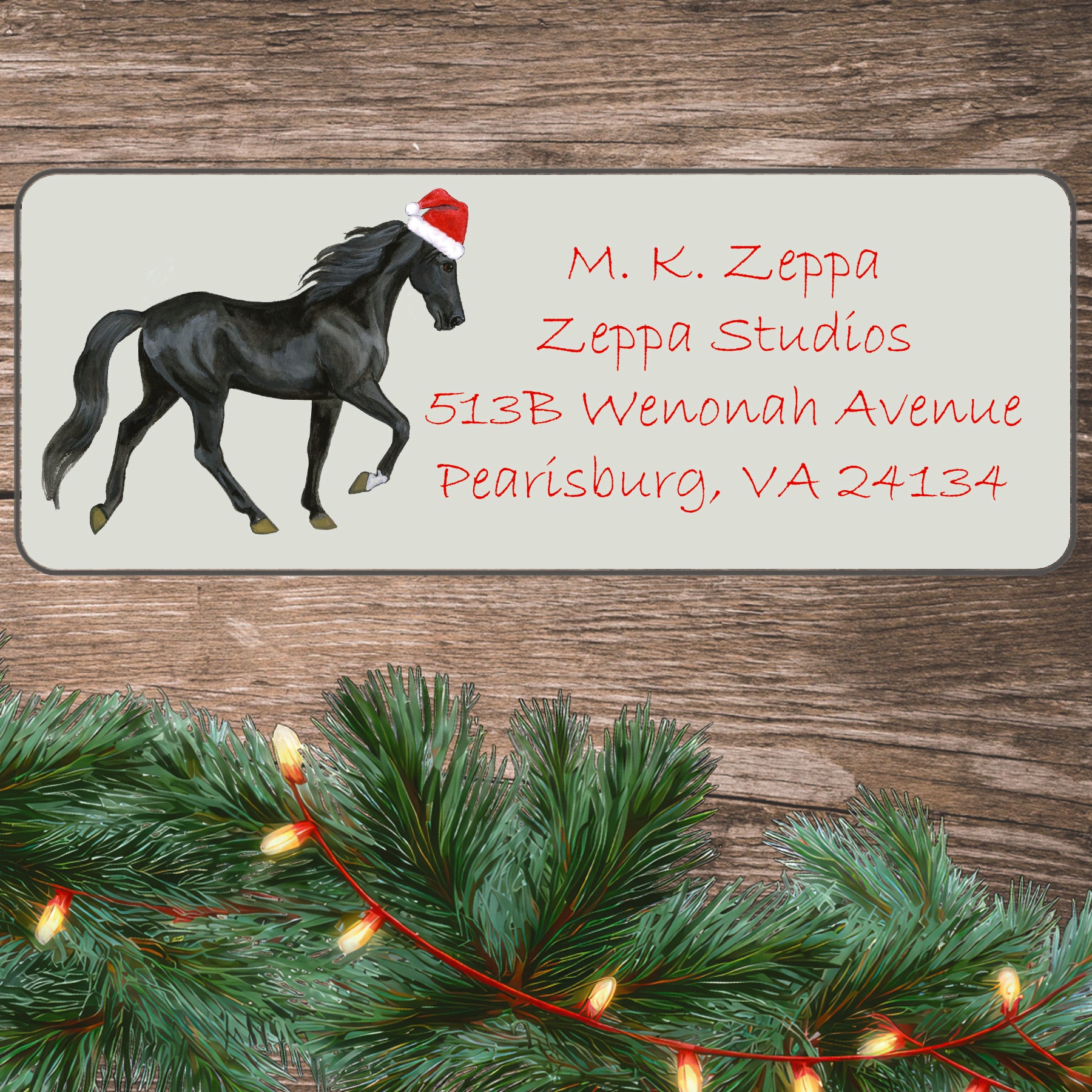 An illustration of a Tennessee Walking Horse wearing a Santa Hat on an ivory return address label set off by a wood surface with holiday greenery background.