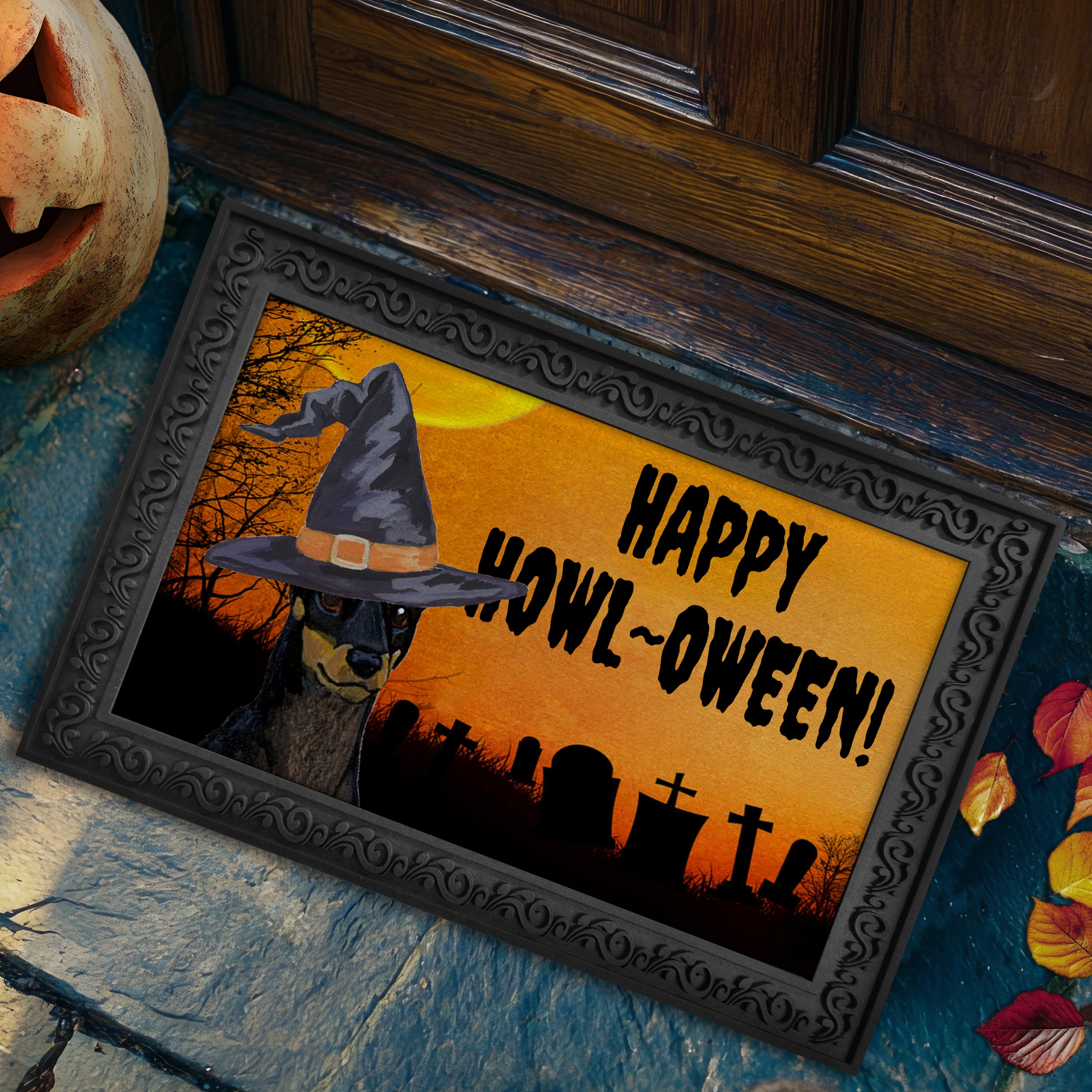 Halloween-themed doormat with a Toy Manchester Terrier wearing a witch hat and 'Happy Howl-Oween!' text.