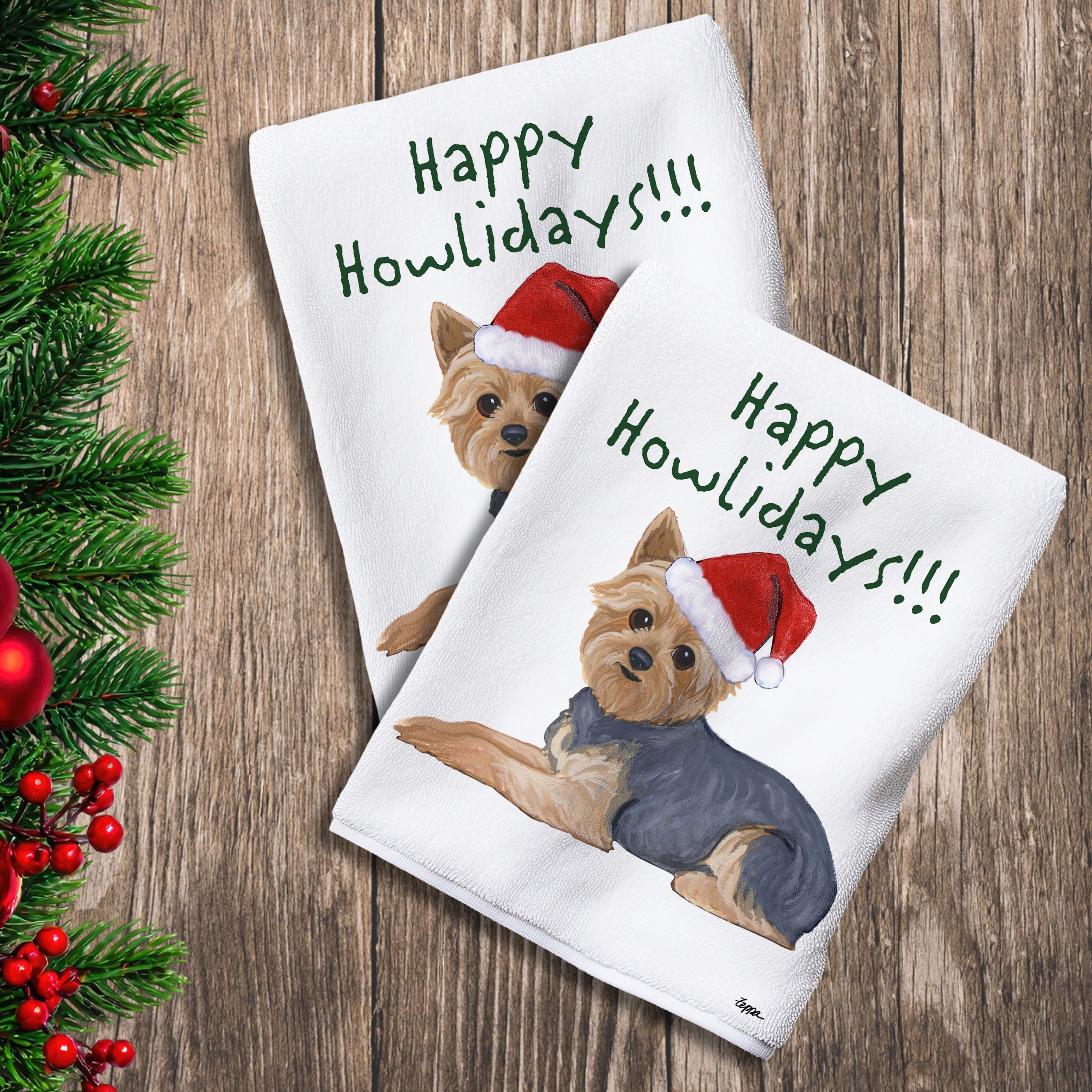 2 Kitchen Towels with a Yorkshire Terrier with a short haircut in a Santa Hat and Happy Howlidays text.
