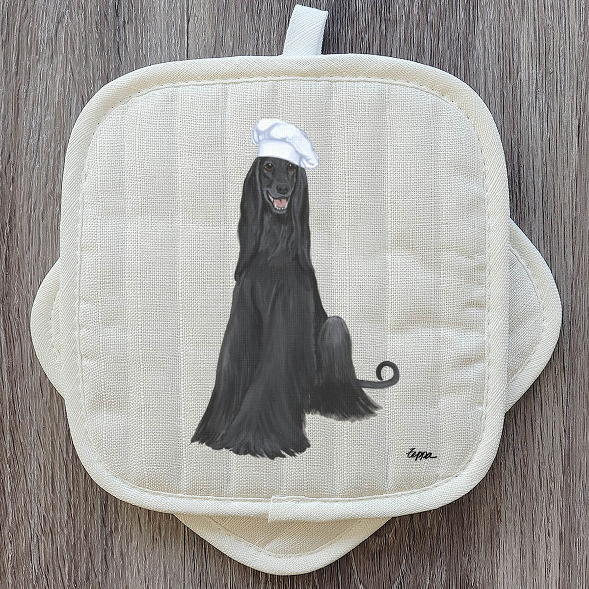 Black Afghan in a chef's hat on a set of Pot Holders