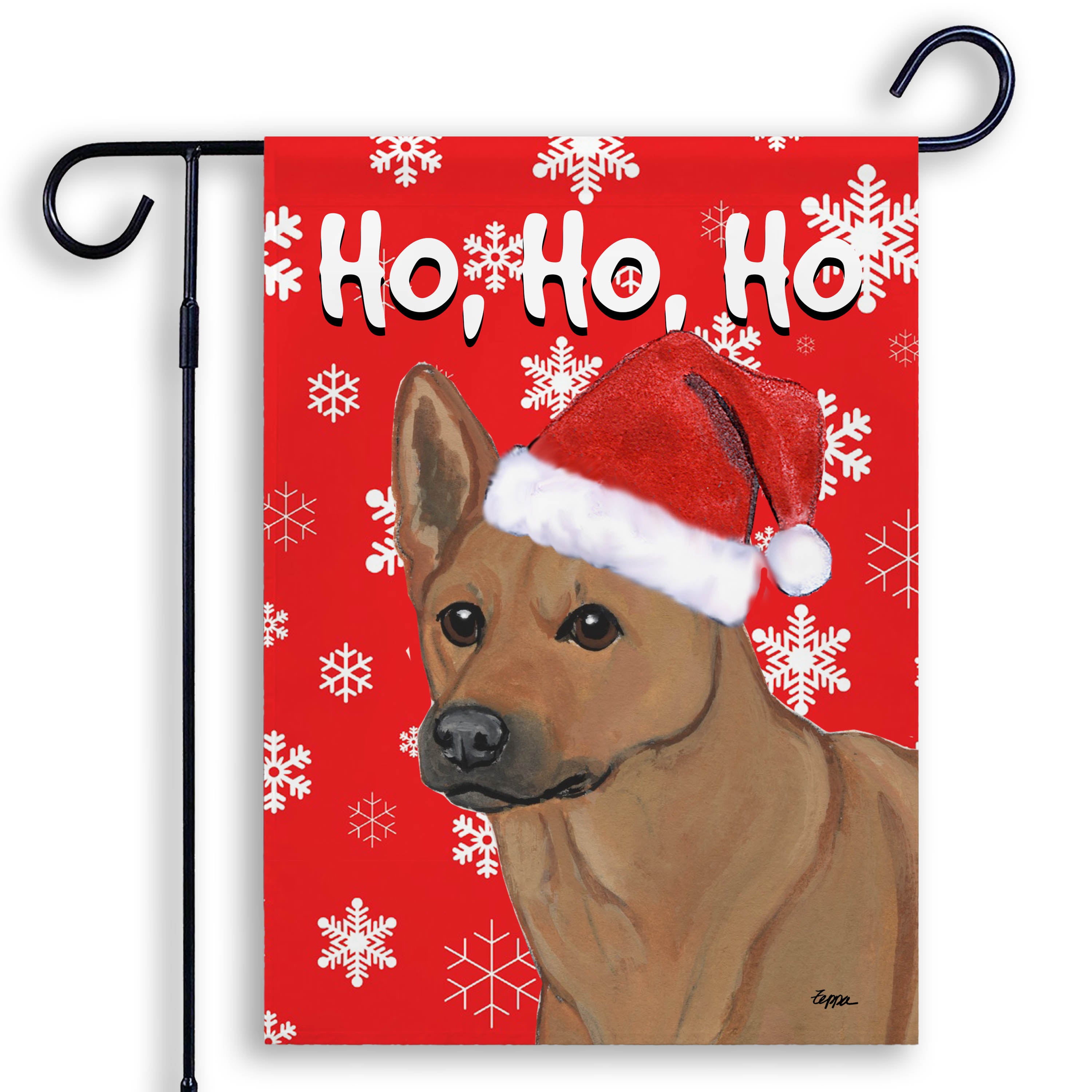 Garden flag with a Carolina dog wearing a Santa hat and 'Ho, Ho, Ho' text on a red background with snowflakes.