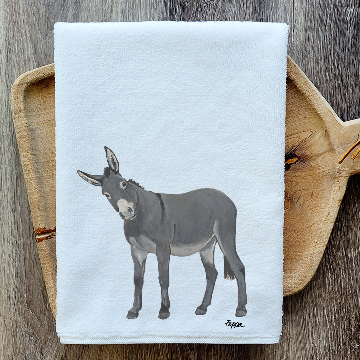 Donkey design on a velour kitchen towel resting on a wooden serving tray.