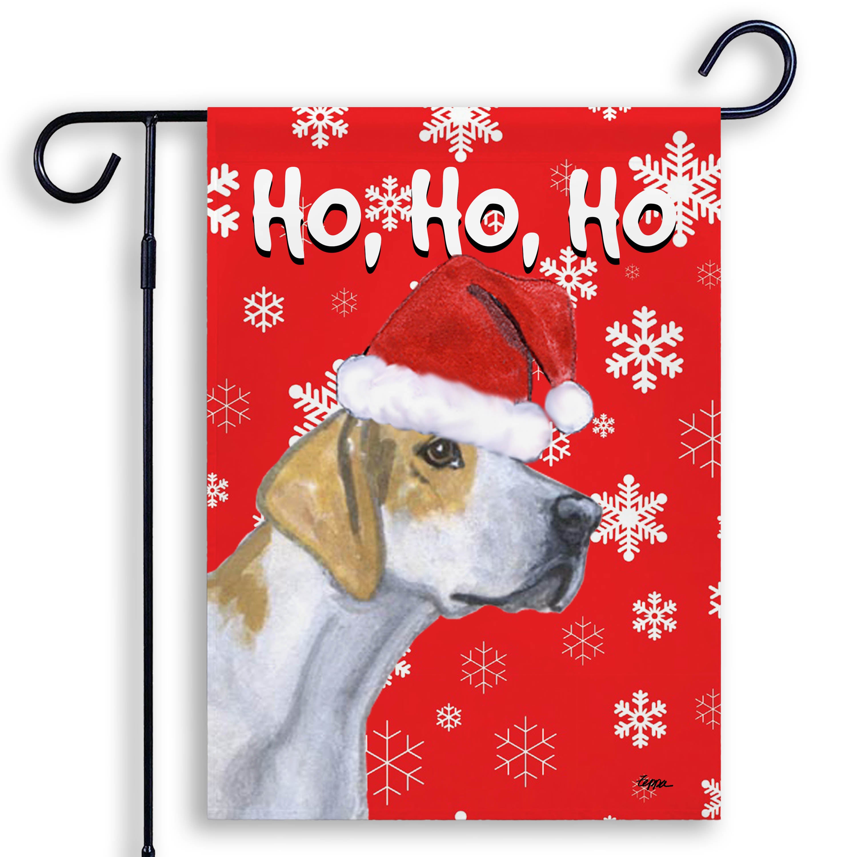 Holiday garden flag with an English Foxhound in a Santa Hat on red snowflake background.