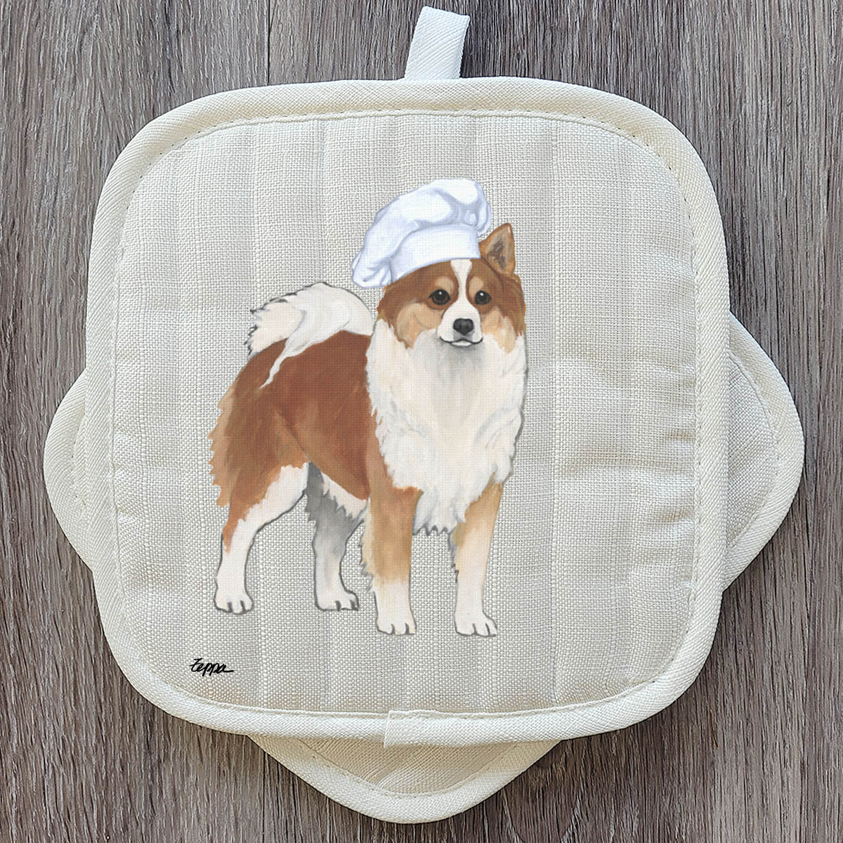 Potholder with an Icelandic Sheepdo wearing a chef's hat on a wooden surface