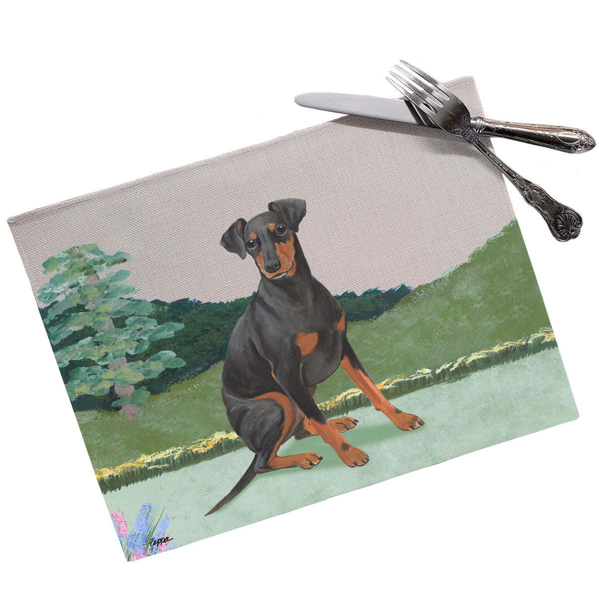 A Manchester Terrier in a yard scene on a linen placemat.