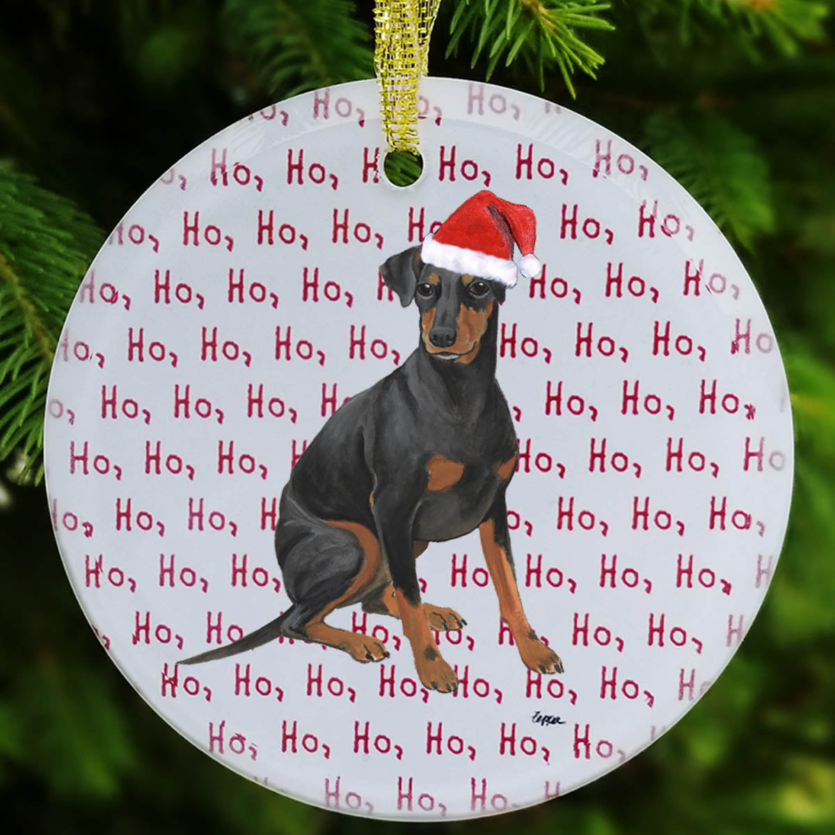 Round frosted glass ornament with a Manchester Terrier in a Santa Hat on a repeating Ho Ho Ho background.
