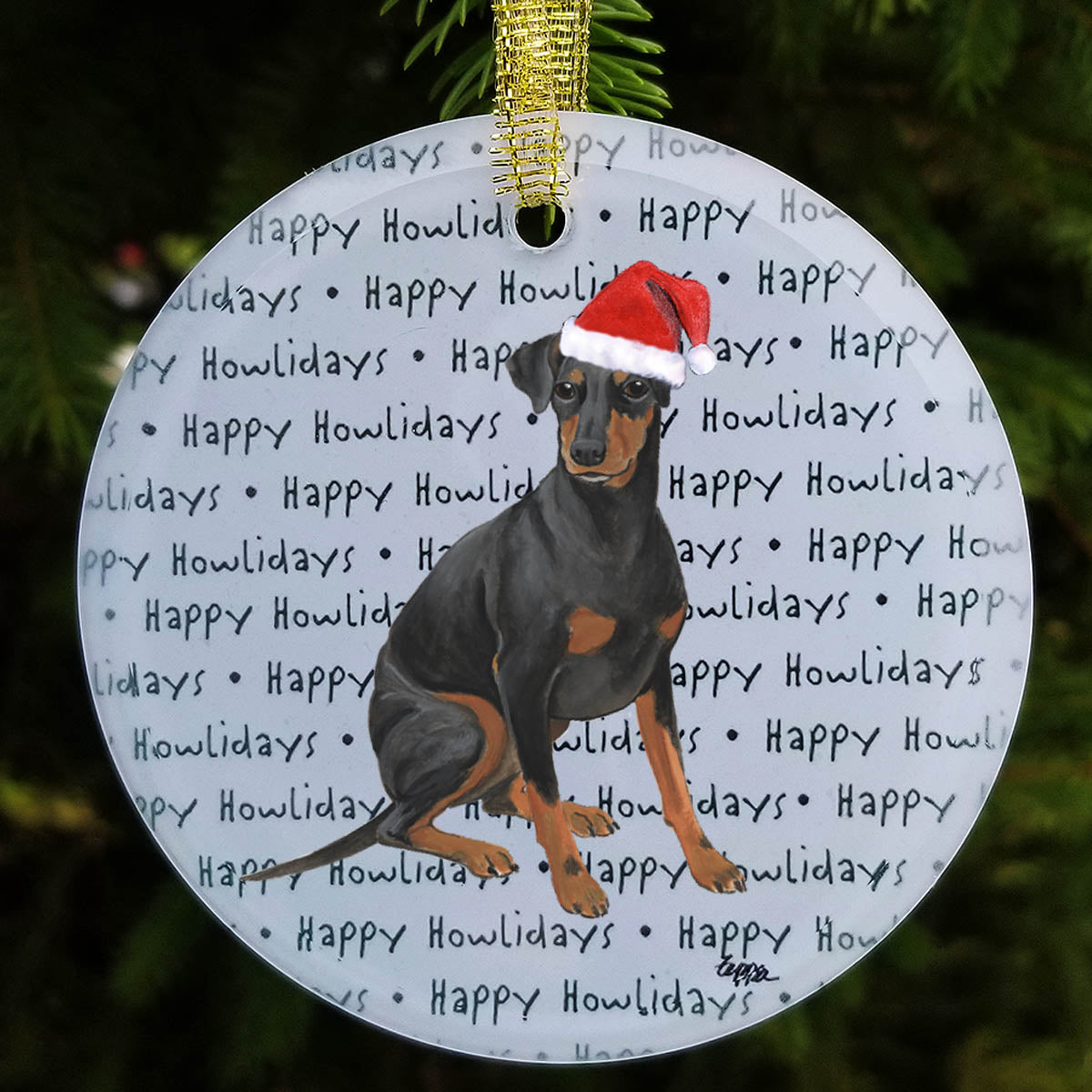 Round frosted glass ornament with a Manchester Terrier in a Santa Hat on a repeating Happy Howlidays background.