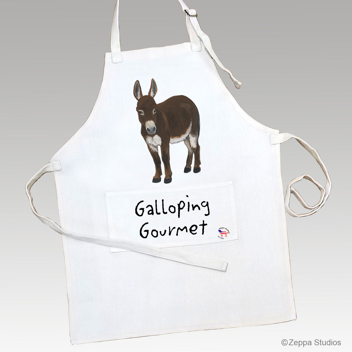 Mini Donkey illustration on a linen apron with the text Galloping Gourmet on the apron's pocket.