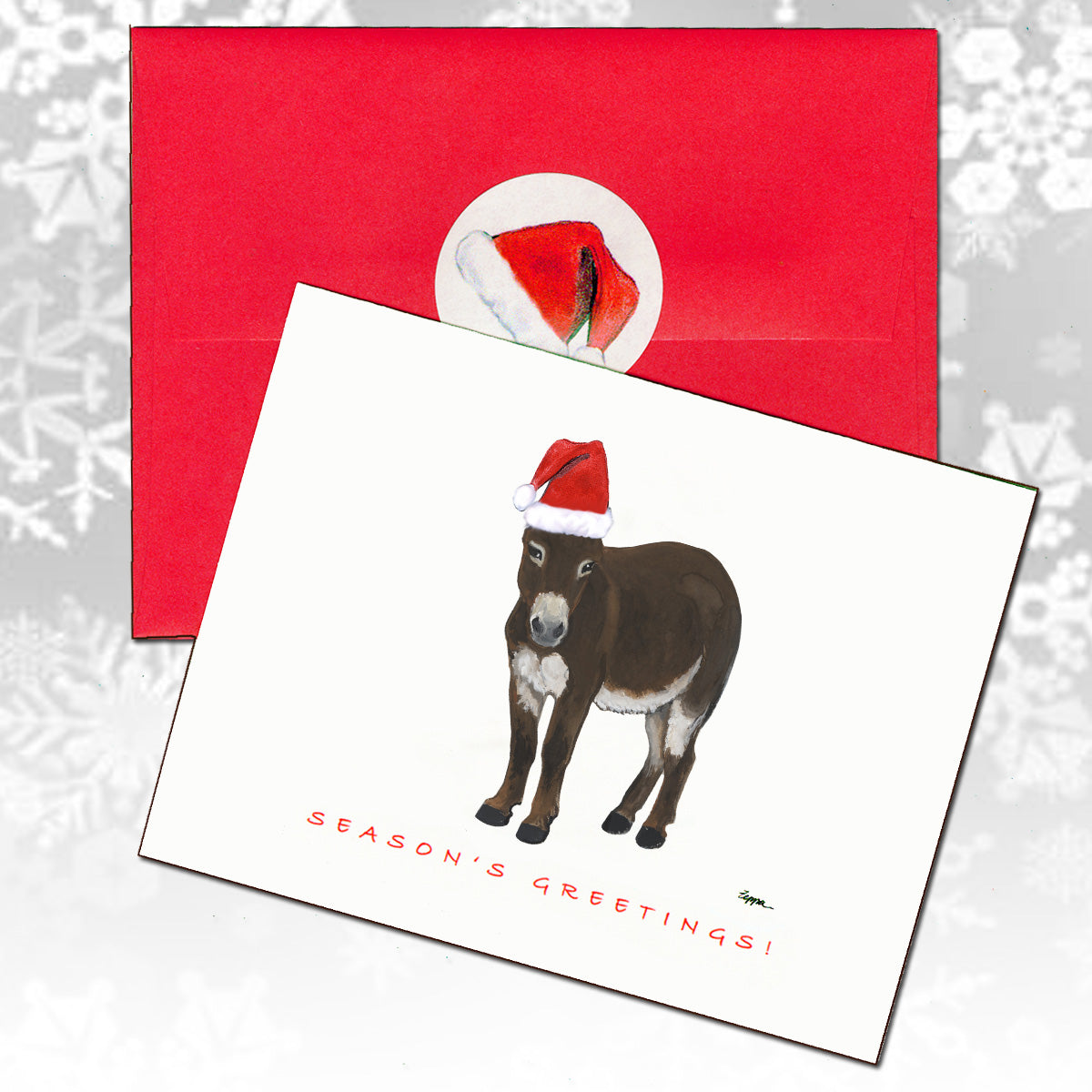A Christmas card featuring an illustration of a mini donkey wearing a Santa hat, shown with a red envelope behind it.