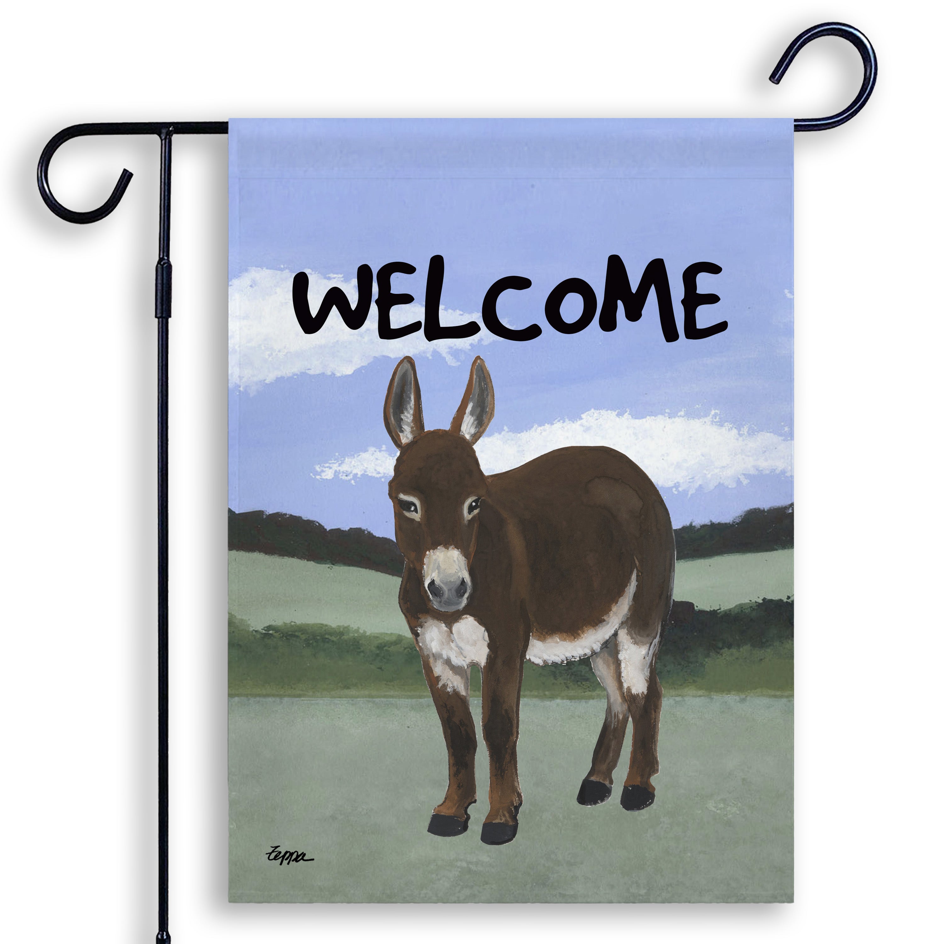 A decorative garden flag hanging from a black metal stand, featuring an illustration of a brown mini donkey in a landscape with  'WELCOME' in large letters at the top.