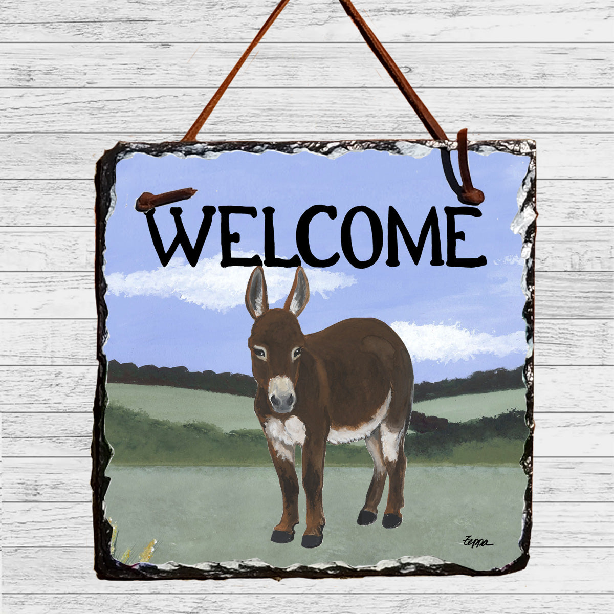 A square Welcome slate hanging sign with a rustic dark border, featuring a brown mini donkey in a green field illustration.