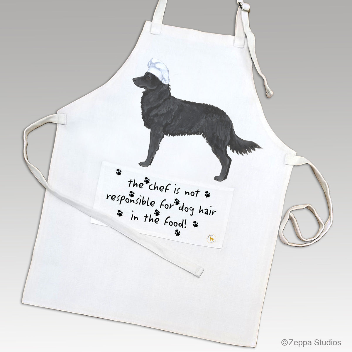 Mudi in a chef's hat on a linen apron