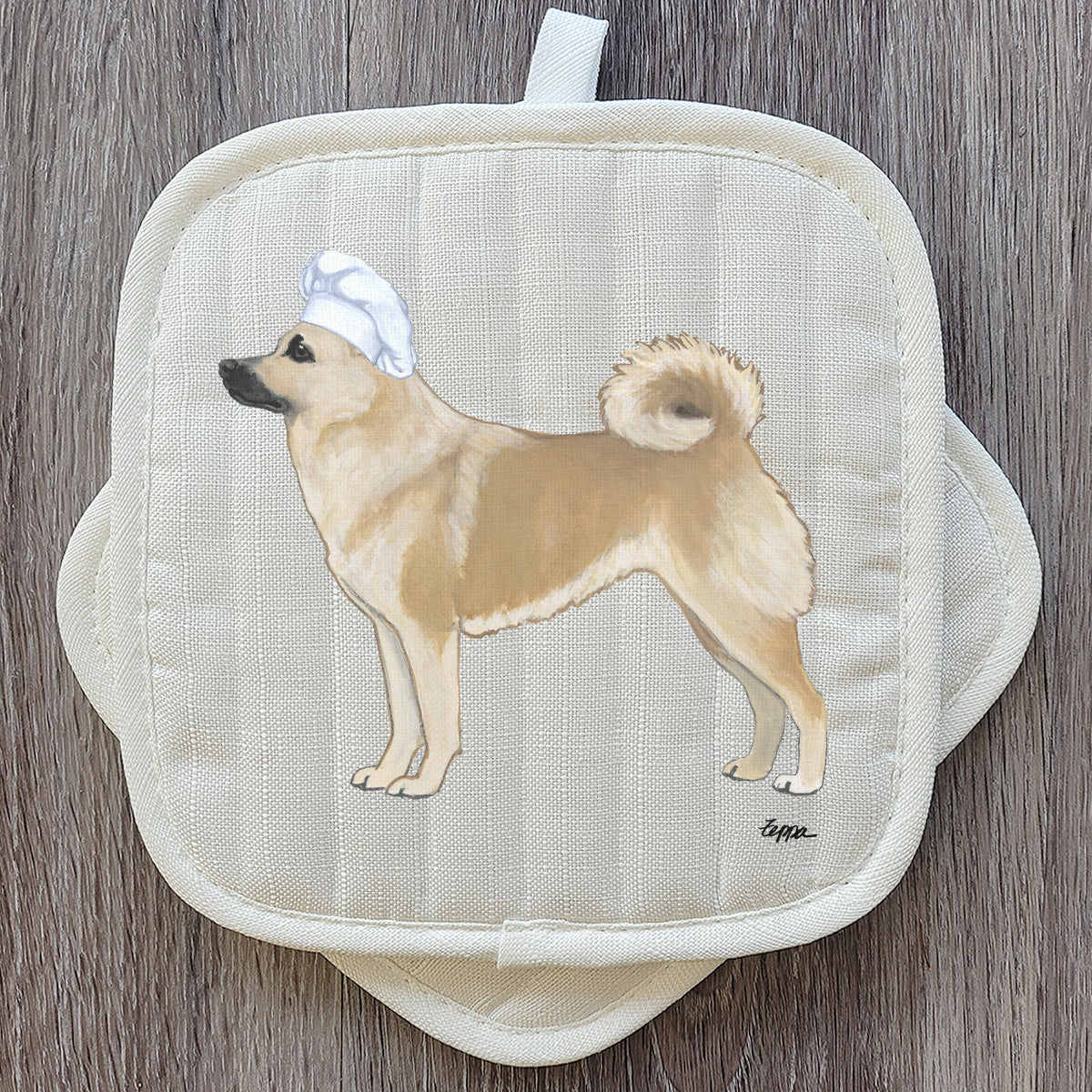 Norwegian Buhund in a chef's hat potholder set.