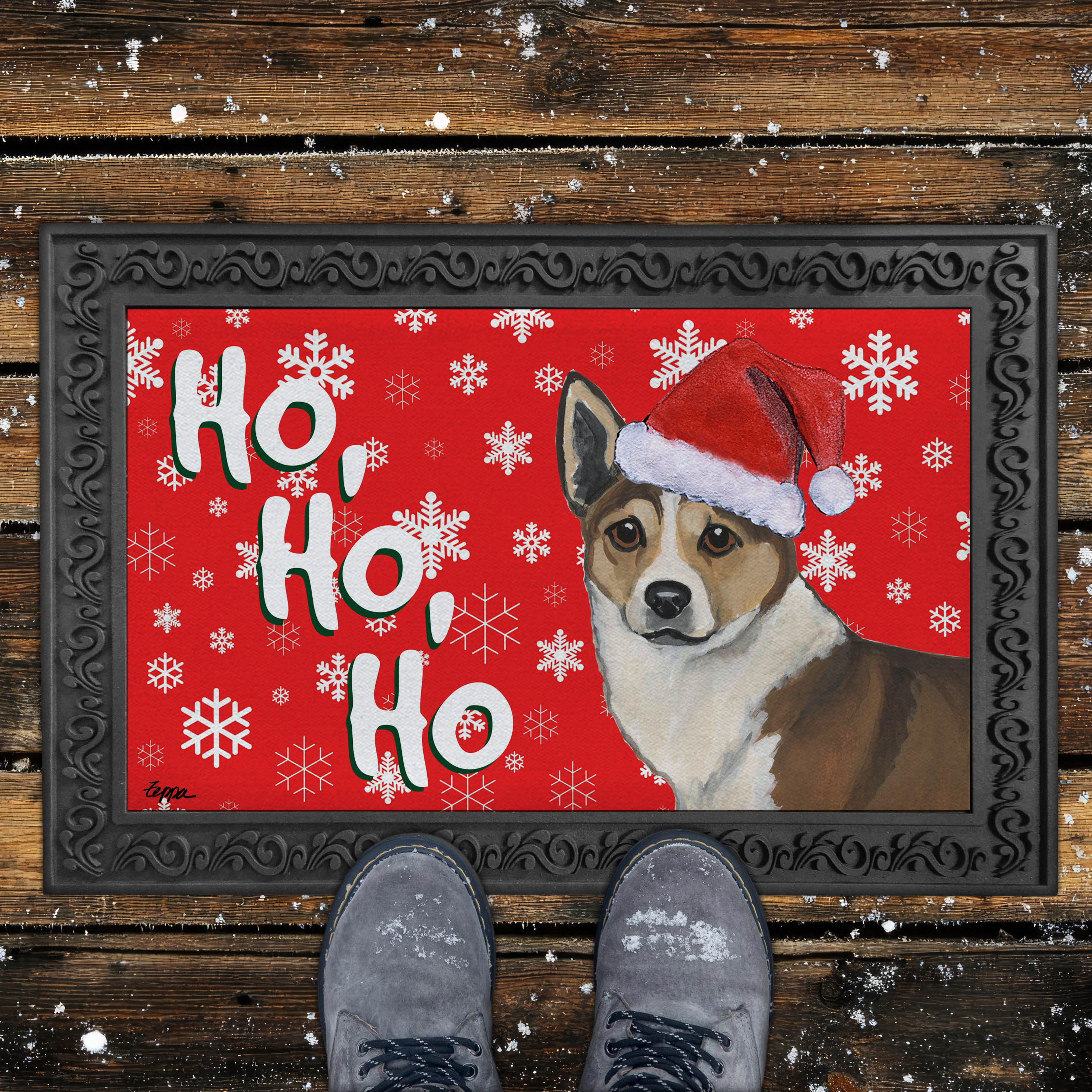 Holiday Doormat with a Norwegian Lundehund in a Santa hat on a red snowflake background.