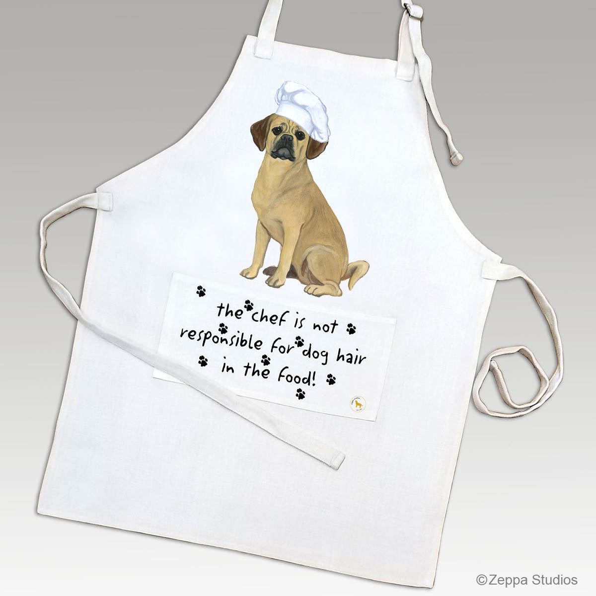 Puggle in a chef's hat on an apron with a funny saying on the pocket.