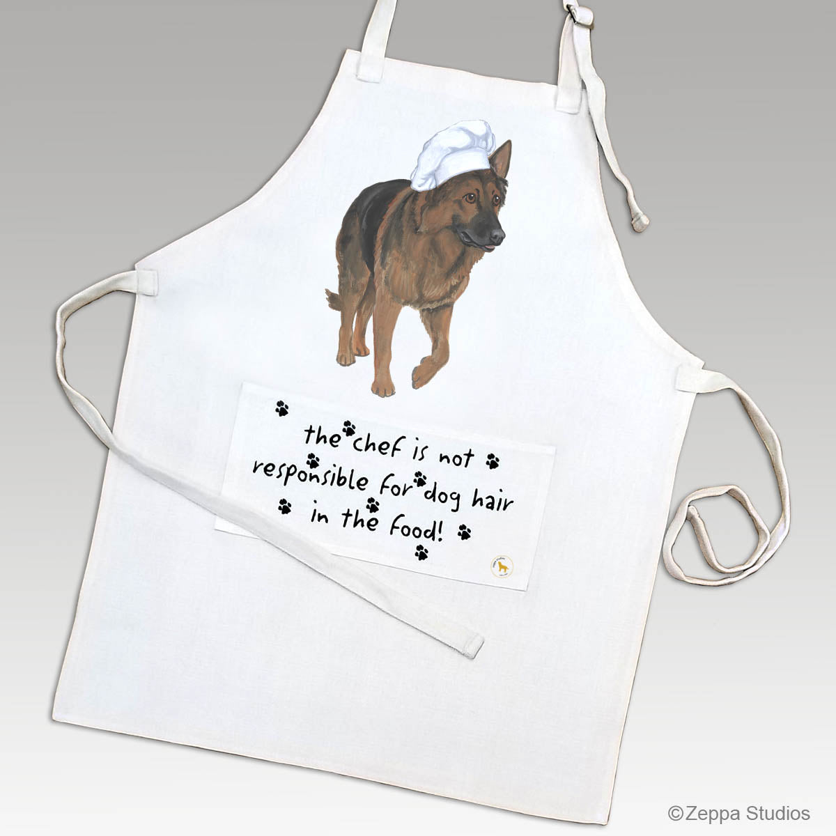 Shiloh Shepherd in a chef's hat on an apron with a funny saying on the pocket.