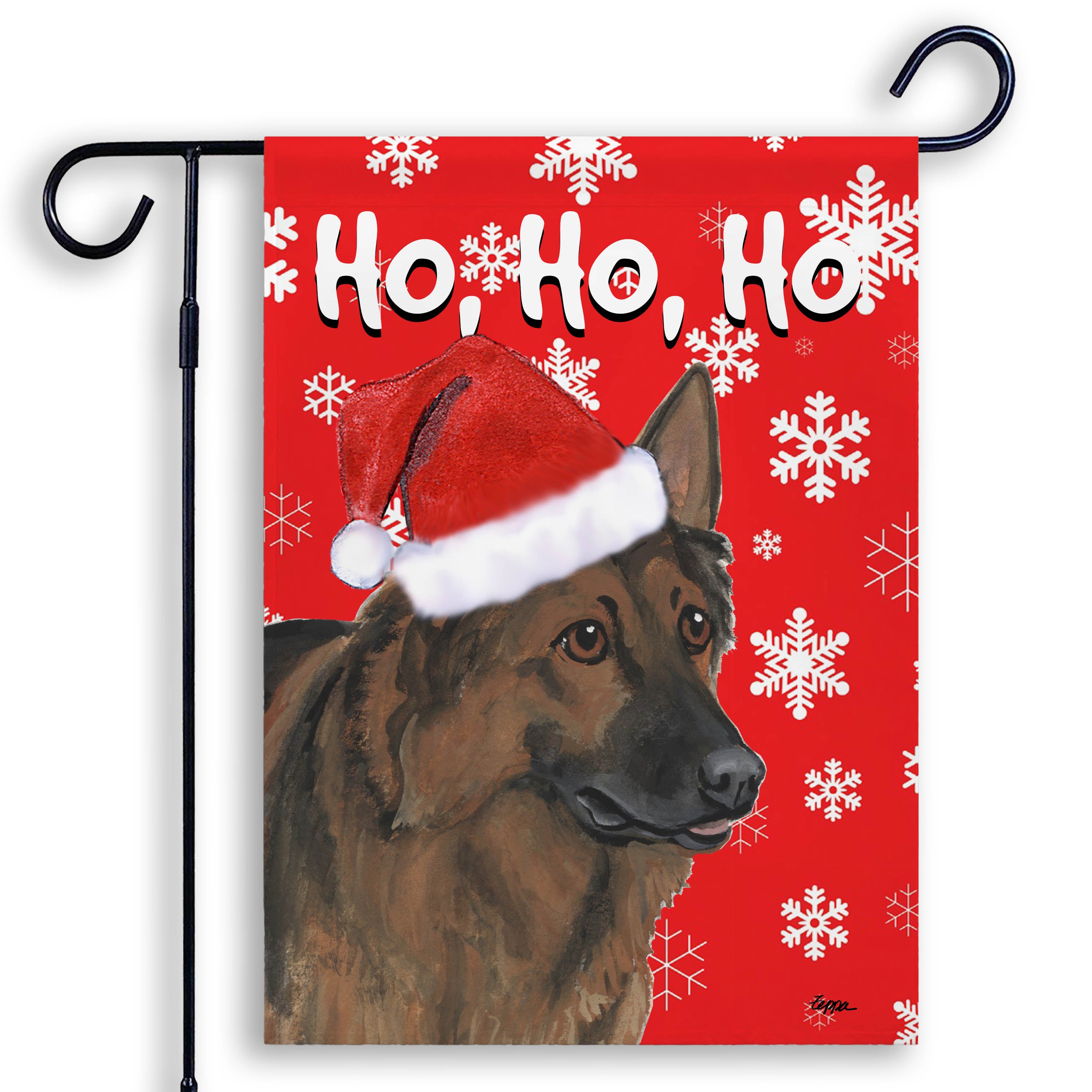 Christmas-themed garden flag with a Shiloh Shepherd wearing a Santa hat and snowflakes on a red background.